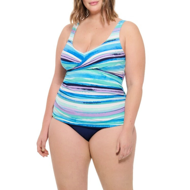 Wave goodbye to uncomfortable beach days with this flirty crossover tankini! Its beautiful blues and oh so sexy silhouette will let you show off your curves while keeping you cozy. Its sleek V-neckline, moulded cup and adjustable straps make it the perfect tankini while the full figure high waist brief will hug you in all the right places. Dive in and take a dip!